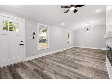 Bright living room with hardwood floors, fireplace, and high ceilings at 358 Roy Sw St, Atlanta, GA 30310