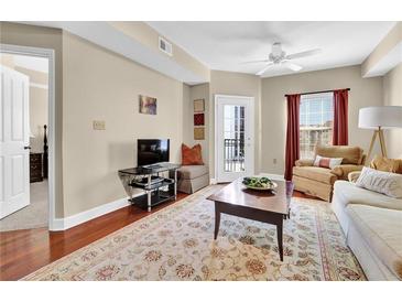 Inviting living room with hardwood floors, area rug, and balcony access at 230 E Ponce De Leon Ave # 516, Decatur, GA 30030