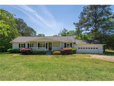 Charming single-story home featuring a welcoming front porch and well-maintained landscaping on a sunny day at 2334 Highway 278, Social Circle, GA 30025