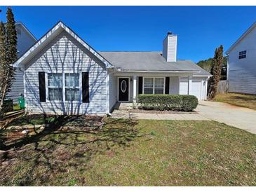 Charming single-Gathering home with neat landscaping, mature trees, and a well-maintained lawn at 6531 Gina Agha Cir, Lithonia, GA 30038