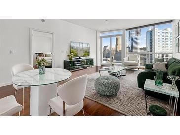 Bright living room with hardwood floors, city views, and comfortable modern furniture at 3325 Piedmont Ne Rd # 1708, Atlanta, GA 30305