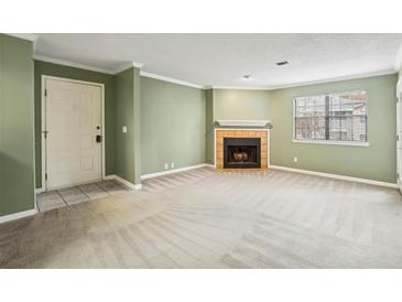 Spacious living room features neutral carpet, fresh paint, and a cozy fireplace at 511 Barrington Hills Dr, Atlanta, GA 30350