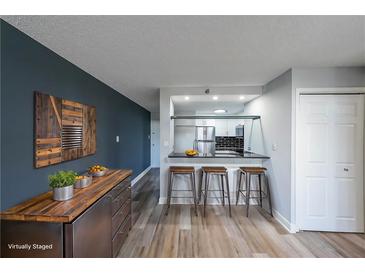 Open kitchen featuring modern countertops, breakfast bar, and stainless steel appliances at 375 Ralph Mcgill Blvd # 603, Atlanta, GA 30312