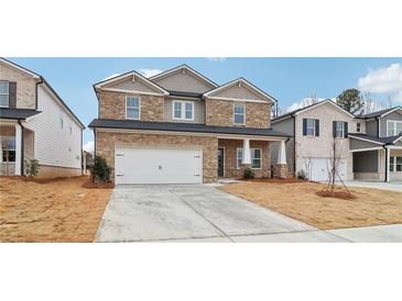 Two-story house with stone accents and a large front yard at 3913 Brushy St, Powder Springs, GA 30127