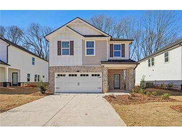 Two-story brick home with a white garage door and landscaping at 4755 Marjorie Dr, Cumming, GA 30041