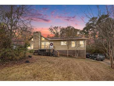 Attractive house exterior at dusk, showcasing a deck and landscaping at 61 Macland Springs Dr, Dallas, GA 30157