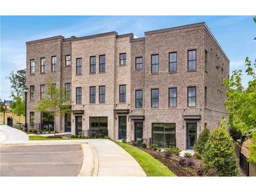 Charming new brick townhomes with sidewalks, landscaping, and a modern architectural design at 822 Urban Grange Way, Suwanee, GA 30024