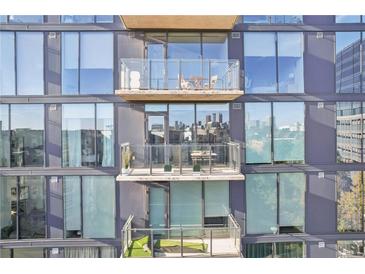 Modern condominium with large windows and outdoor balconies with seating areas at 788 W Marietta Nw St # 403, Atlanta, GA 30318