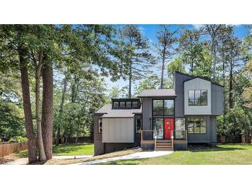 Modern two-story home with gray and white exterior, nestled among trees at 3483 Winter Chase Dr, Marietta, GA 30062