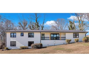 Ranch style home with white brick exterior, updated features and landscaping at 1755 Smithwood Dr, Marietta, GA 30062