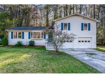 Charming two-story home with a well-maintained lawn and a two-car garage at 3090 Karen Ne Ln, Marietta, GA 30062