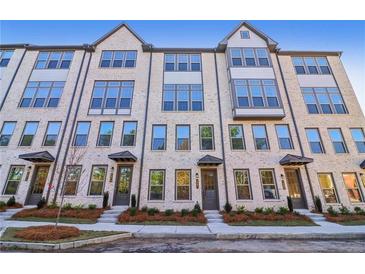 Three-story townhouses with brick facade and modern design at 3879 Allegretto Cir # 116, Atlanta, GA 30339