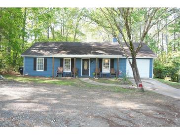 Charming single-story home with a covered porch, blue siding, and inviting curb appeal at 4120 Highway 92, Acworth, GA 30102