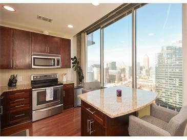 Modern kitchen with stainless steel appliances and granite countertops at 855 Peachtree Ne St # 2412, Atlanta, GA 30308