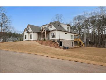 Two-story home with stone accents and a large yard at 325 Mont Harmony Sw Rd, Powder Springs, GA 30127