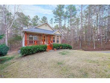Brick ranch home with front porch, nestled in a wooded setting at 2158 Belcourt Dr, Villa Rica, GA 30180