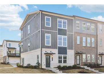 Modern townhome showcasing mixed siding, white brick, multiple windows, and a welcoming entrance at 434 Herring Dr, Acworth, GA 30102