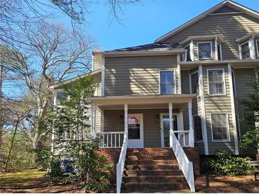 Charming two-story home with brick stairs and a covered entryway, perfect for a cozy welcome at 1409 Oakridge Cir, Decatur, GA 30033