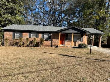 Brick ranch house with a carport and well-maintained lawn at 5380 Saint Lo Ln, Atlanta, GA 30349