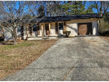 Newly renovated Ranch home with updated exterior and driveway at 5312 Westford Cir, Atlanta, GA 30349