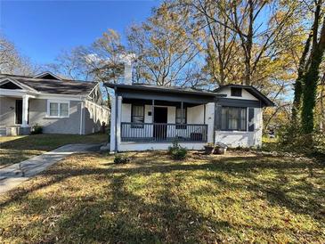 Charming white brick home with gray trim and a covered porch at 880 Cascade Sw Rd, Atlanta, GA 30311