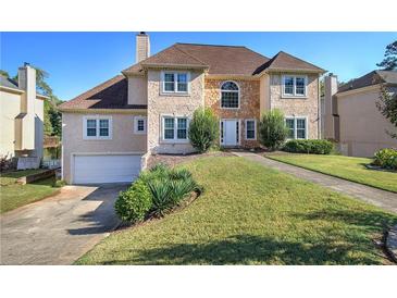 Charming two-story home with a well-manicured lawn and attached two-car garage at 3634 Autumn Ridge Pkwy, Marietta, GA 30066