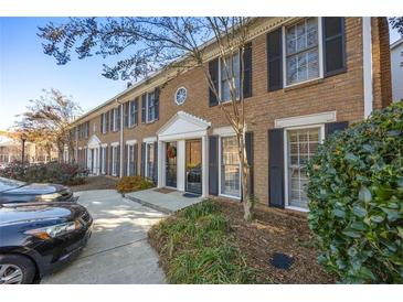 Well-maintained townhomes with landscaped yards and ample parking at 1101 Collier Nw Rd # V6, Atlanta, GA 30318