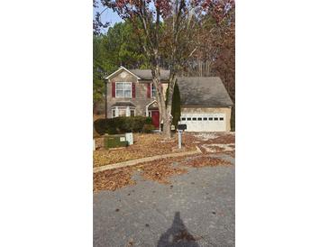 Traditional two-story home with a two-car garage and front yard with a tree at 113 Ambridge Ct, Lawrenceville, GA 30044