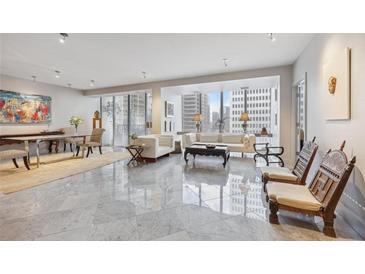 Bright living room featuring marble floors, modern furniture, and large windows with city views at 147 15Th Ne St # 10C, Atlanta, GA 30309