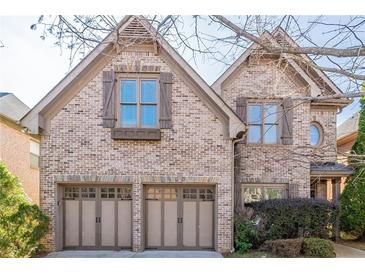 Brick two-story house with three-car garage and mature trees at 129 Janney Cir, Mcdonough, GA 30253