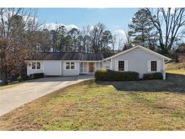 Ranch style home with a landscaped lawn and driveway at 3562 Ontario Ct, Buford, GA 30519