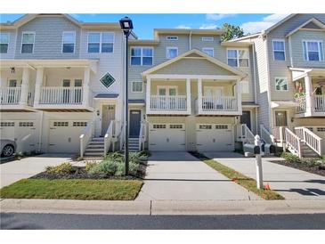Charming townhome with private garages and inviting covered porches and front yard at 1081 Liberty Pkwy, Atlanta, GA 30318