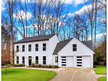 Charming two-story home with a two car garage and neatly manicured lawn at 3290 Ethan Dr, Marietta, GA 30062