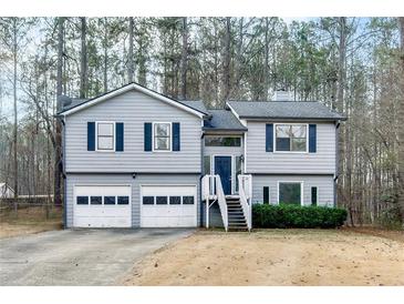 Split level home with a 2-car garage and a staircase leading to the front door at 336 Adelene Way, Dallas, GA 30157