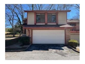 Charming two-story townhome featuring a two-car garage and mature trees at 1153 Village Main St, Stone Mountain, GA 30088