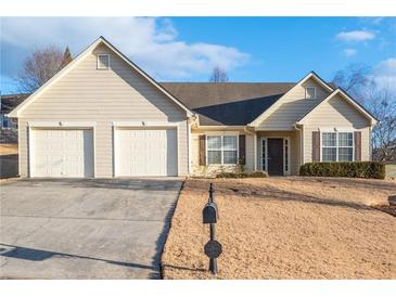 Inviting single-story home with a two-car garage and well-maintained front lawn at 3041 Lexington Ave, Woodstock, GA 30189