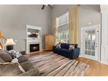 Bright living room boasts a fireplace, soaring ceilings and large windows with lots of natural light at 2352 Kelman Pl, Dacula, GA 30019