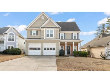 Two-story home with a two-car garage, brick accents, and manicured landscaping at 2818 Colleton Dr, Marietta, GA 30066