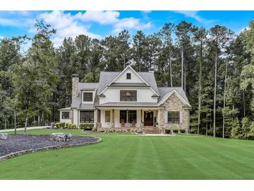 Stunning farmhouse exterior with stone accents and a manicured lawn at 5341 Hill Nw Rd, Acworth, GA 30101