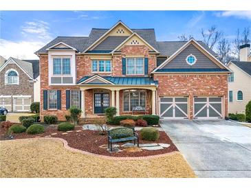 Brick two-story house with a three-car garage and landscaped yard at 1251 Irwin Lake Way, Marietta, GA 30064