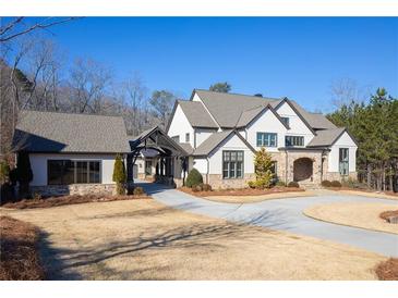Stunning two-story home with stone accents and a three-car garage at 5152 Boulder Bluff Way, Suwanee, GA 30024