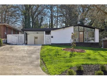 Ranch style home with modern exterior and landscaped lawn at 2592 Baker Nw Rd, Atlanta, GA 30318