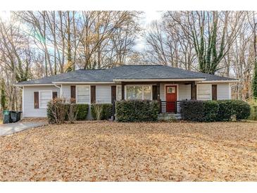 Charming ranch home with landscaped yard and red front door at 4598 Flint Hill Rd, Austell, GA 30106