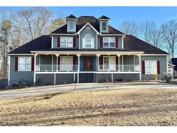 Two-story house with wrap-around porch, gray siding, and red shutters at 447 Cotton Mill Dr, Hiram, GA 30141