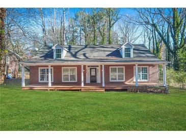 Brick house with front porch and landscaped lawn at 3404 Mount Olive Rd, Atlanta, GA 30344