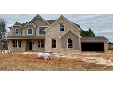 Two-story brick home with large windows and attached garage at 4010 Sierra Vista Cir, Cumming, GA 30040