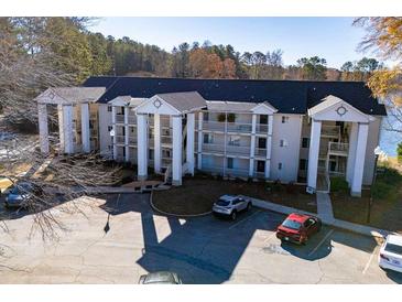 Three story building with parking lot in front, offering multiple balconies and lake views at 706 Berry Ct, Villa Rica, GA 30180