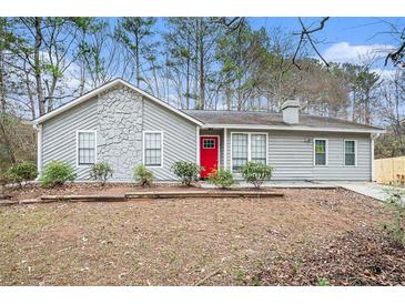 Gray house with red door and stone accents at 5632 Rock Springs Rd, Lithonia, GA 30038
