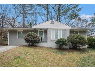 Gray Ranch house with manicured lawn and shrubs at 1983 Wee Kirk Se Rd, Atlanta, GA 30316
