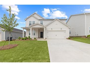 Charming two-story home with manicured lawn, inviting front porch, and attached two-car garage at 3340 Redwood Ct, Covington, GA 30016